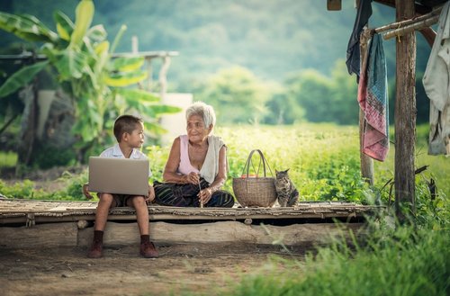 Student with laptop and his grandmother